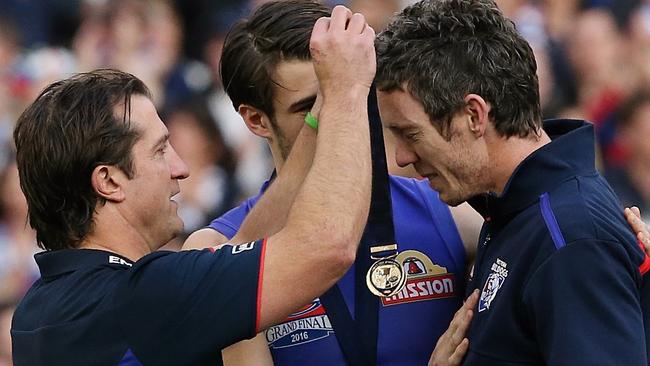 Luke Beveridge gives Bob Murphy his premiership medal. Picture: Wayne Ludbey