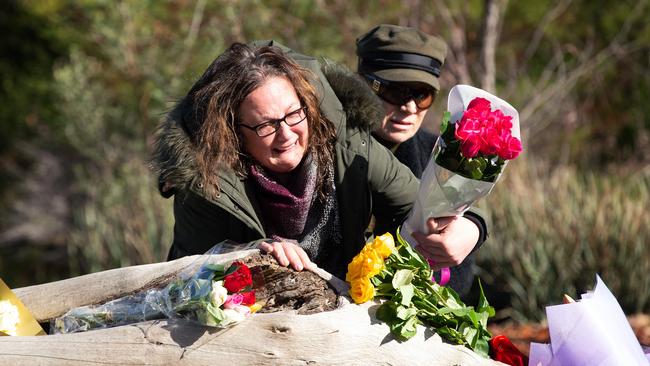 Courtney’s devastated mum lays flowers at the logs where her body was found. Picture: Sarah Matray