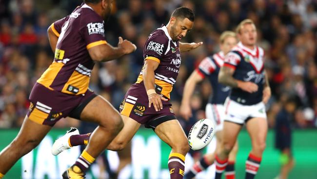 Benji Marshall sends a kick downfield for the Broncos against the Roosters on Friday night.