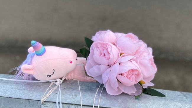 Floral tributes and a small toy unicorn lay at the fatal crash site on Algona Road, where a Huntingfield father and his young daughter were killed in a car crash. Photo: Phil Young