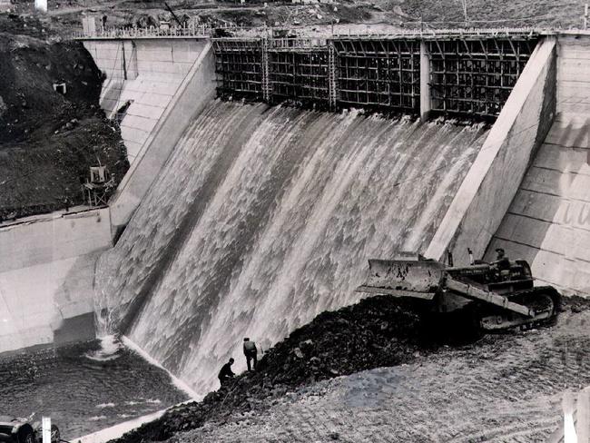 Water pouring over the spillway of Guthega Dam 5, a 100-foot mass concrete gravity dam that is part of Snowy Mountains scheme.