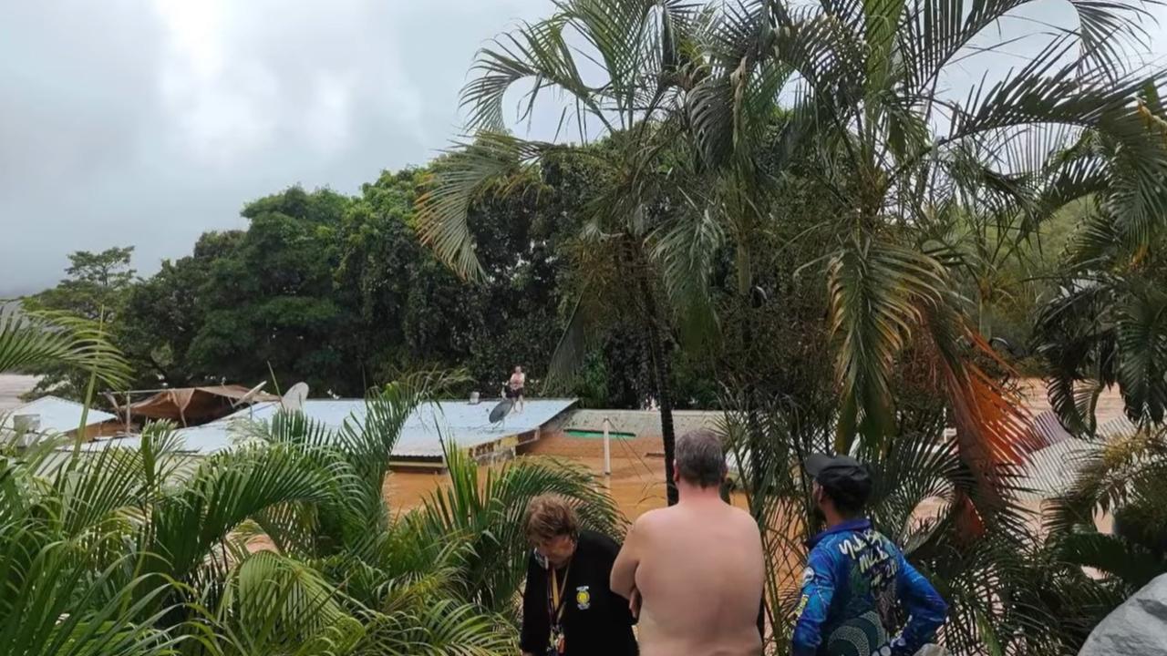 The Lions Den Hotel staff on the roof of the hotel waiting to be rescued by chopper pilot Migaloo. Picture: Lions Den Hotel