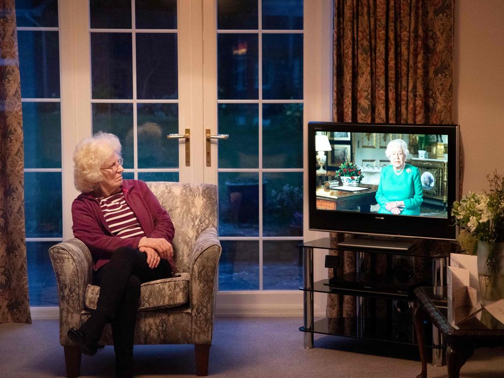 Val Cloke sits in her living room in the village of Hartley Wintney, west of London, and watches the Queen’s speech. Picture: AFP