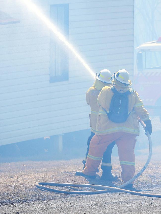 Firefighters try to save a house at North Rothbury. Picture: Peter Lorimer.