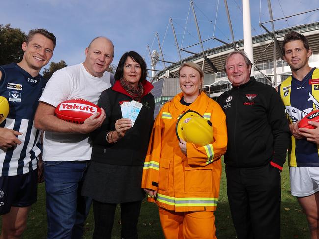 Kevin Sheedy and Billy Brownless outside the MCG with a dairy farmer Sally Mitchell from Torrumbarry and CFA volunteer Josie Roche of the Bayswater Fire Brigade prior to next saturday's Round 8 Country Game between Essendon and Geelong. Also in pic is Jason Davenport (left) of the Geelong Netball football league and Rikki Johnston (right) of the Mornington Peninsula Nepean football league who will play in the curtain raiser . Pic: Michael Klein