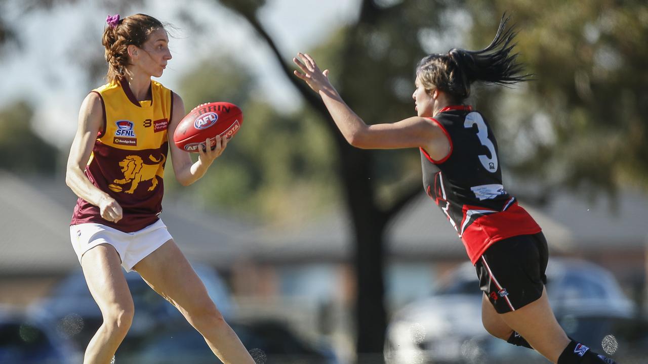 South East Women’s: Julia Hockey of Murrumbeena handballs under pressure from Skye’s Tiffany Clark. Picture: Valeriu Campan