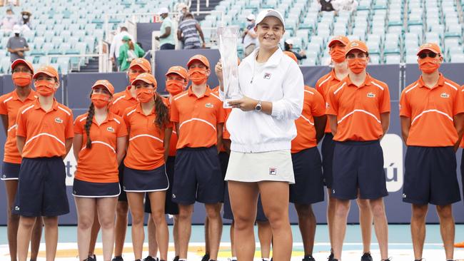 Ash Barty with the Miami Open trophy, which has been sent home to mum and dad