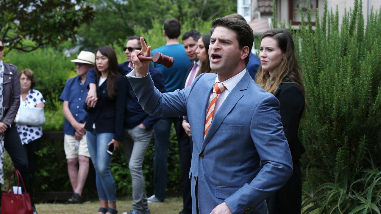 Auctioneer Oliver Burton at a north shore home that passed in at auction. Picture: David Swift.