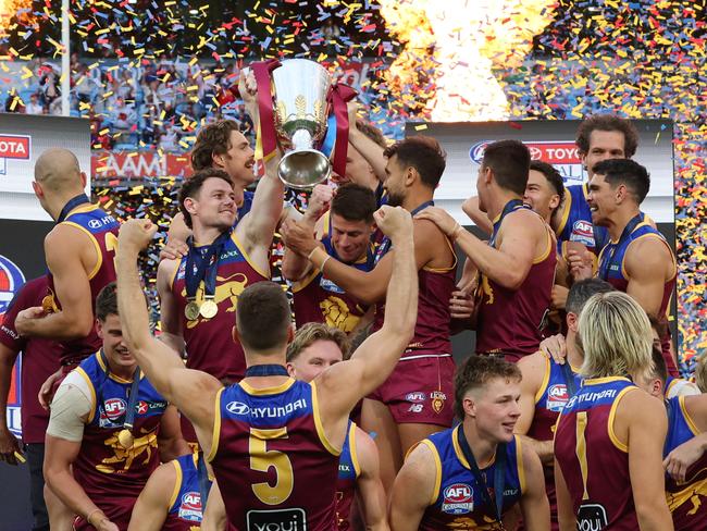 Brisbane Lions players celebrate with the premiership cup after winning the AFL Grand Final after defeating the Sydney Swans at the MCG. Picture Lachie Millard