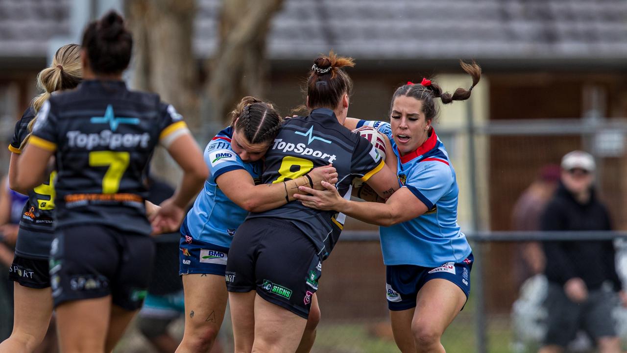 Zoe Cook (left) and Tara Reinke wrap up a Tweed Seagulls player. Picture: Benny Hassum Photography