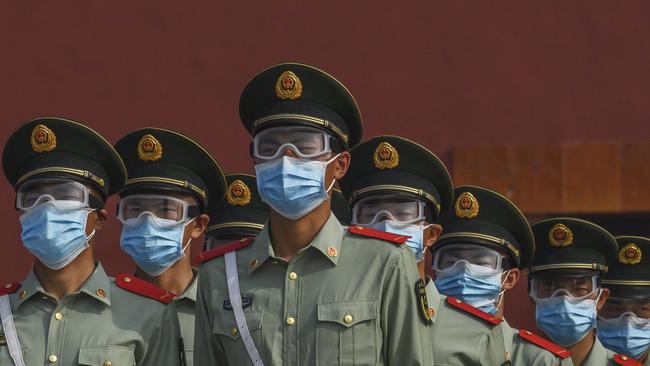 Chinese paramilitary police wear protective masks as they guard the entrance to the Forbidden City as it re-opened to limited visitors for the May holiday, on May 2, 2020 in Beijing, China. (Photo by Kevin Frayer/Getty Images)