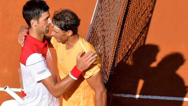 Spain's Rafael Nadal (R) is congratulated by Serbia's Novak Djokovic after winning their semi final match at Rome's ATP Tennis Open tournament at the Foro Italico, on May 19, 2018 in Rome. / AFP PHOTO / TIZIANA FABI