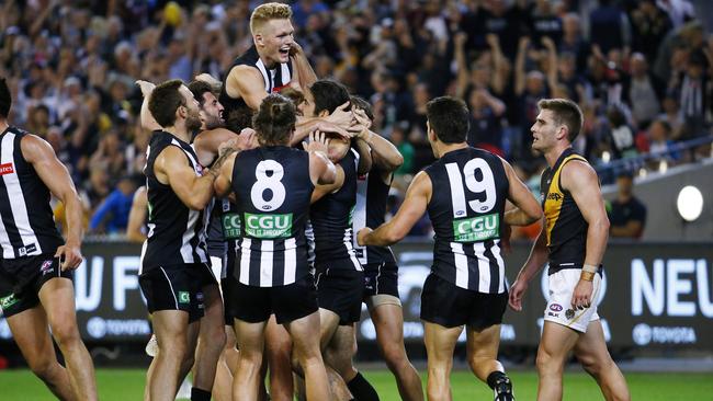 Collingwood players swamped Brodie Grundy after he kicked the winning goal. Picture: Colleen Petch