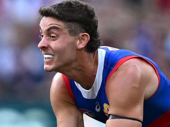 MELBOURNE, AUSTRALIA - MARCH 17: Nick Coffield of the Bulldogs handballs whilst being tackled during the round one AFL match between Melbourne Demons and Western Bulldogs at Melbourne Cricket Ground, on March 17, 2024, in Melbourne, Australia. (Photo by Quinn Rooney/Getty Images)