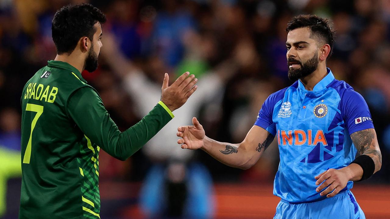 India's Virat Kohli shakes hands with Pakistan's Shadab Khan. Photo by Martin KEEP / AFP