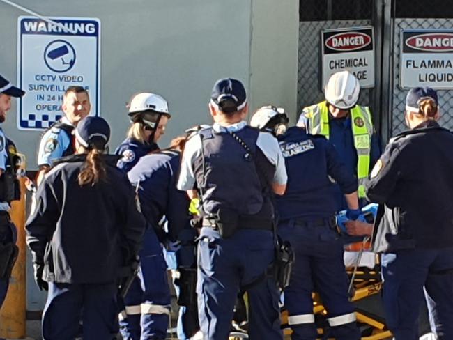 A man was freed after becoming trapped in a cardboard compacting machine in Liverpool.