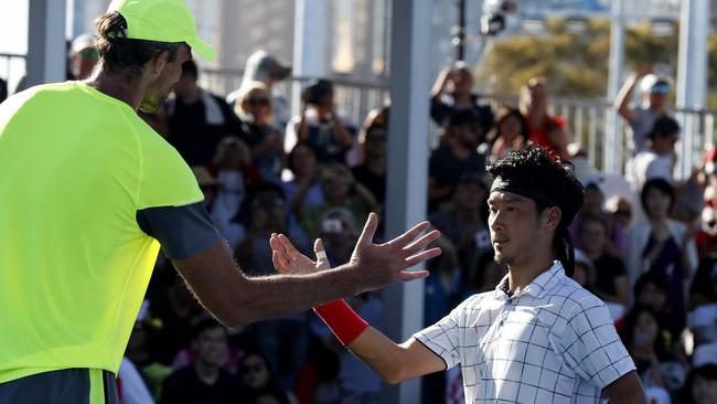 Tall order ... Croatia's Ivo Karlovic, left, shakes hands with Japan's Yuichi Sugita after their second round match at the Australian Open. Photo: AP