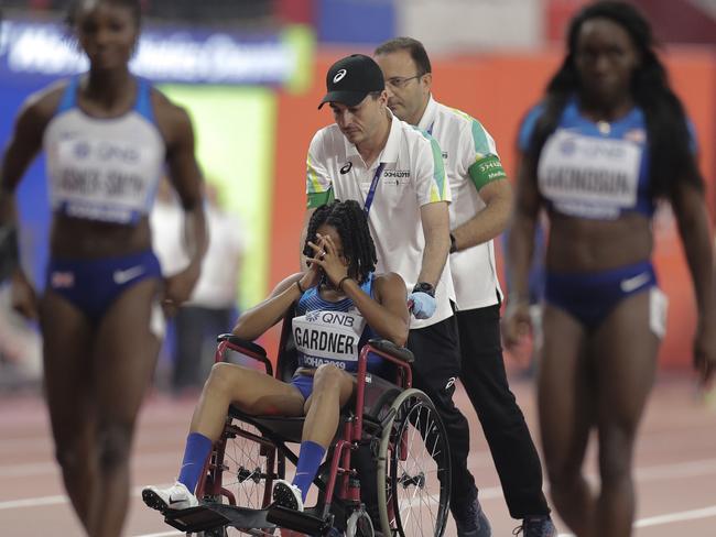 English Gardner covers her face after getting injured.