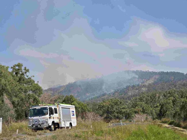 Emergency services at the scene of multiple fires on Mount Morgan range on September 22, 2024. SES have road blocks on the Burnett Hwy as Queensland Fire Brigade crews battle the fires, including using a helicopter to drop water from the air.