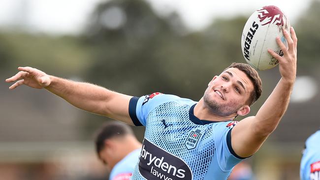 Nathan Cleary stretches for the ball at Blues training.