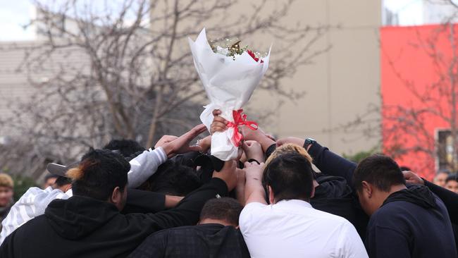 Students gathered in a huddle to farewell their friend. Picture: Wayne Taylor