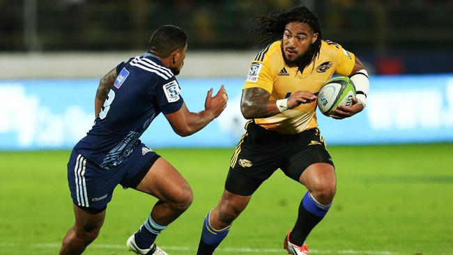 Ma'a Nonu of the Hurricanes attempts to evade Charles Piutau of the Blues.