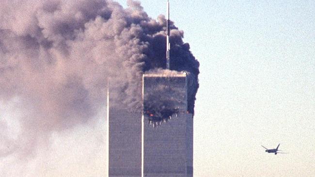 (FILES) In this file photo taken on September 11, 2001, a hijacked commercial aircraft approaches the twin towers of the World Trade Center shortly before crashing into the landmark skyscraper in New York. - The remains of two more victims of 9/11 have been identified, thanks to advanced DNA technology, New York officials announced on September 7, 2021, just days before the 20th anniversary of the attacks. The office of the city's chief medical examiner said it had formally identified the 1,646th and 1,647th victim of the al-Qaeda attacks on New York's Twin Towers which killed 2,753 people. (Photo by SETH MCALLISTER / AFP)