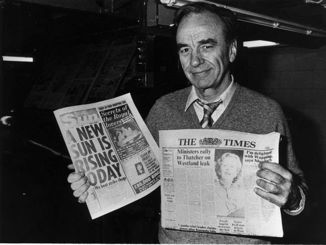 News Corporation chairman and CEO Rupert Murdoch holds up editions of The Sun (L) and The Times newspapers hot off the presses at their production centre in London in 1986.