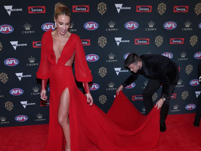 Trent Cotchin of Richmond and his wife Brooke Cotchin pose for a photograph on the red carpet at the 2018 Brownlow Medal ceremony at the Crown Palladium in Melbourne, Monday, September 24, 2018. The Brownlow medal is awarded to the the AFL's best and fairest player. (AAP Image/David Crosling) NO ARCHIVING, EDITORIAL USE ONLY