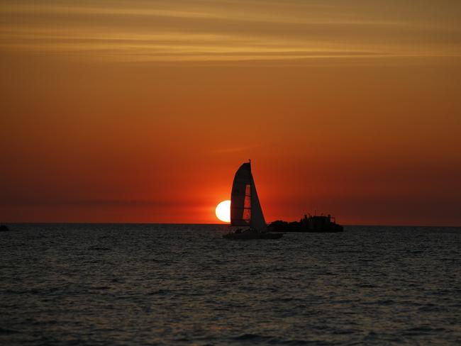 The sun sets as Darwinites gather along the shores of Darwin Harbour to celebrate Territory Day. Picture: Glenn Campbell
