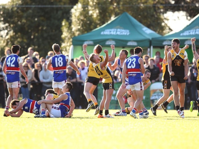 MELBOURNE, AUSTRALIA - SEPTEMBER 21:  YCW players celebrate the win on the final siren during the Peninsula Football Netball League Grand Final match between the Mornington Bulldogs and the Frankston YCW at Frankston Park on September 21, 2014 in Melbourne, Australia.  (Photo by Michael Dodge/Getty Images)