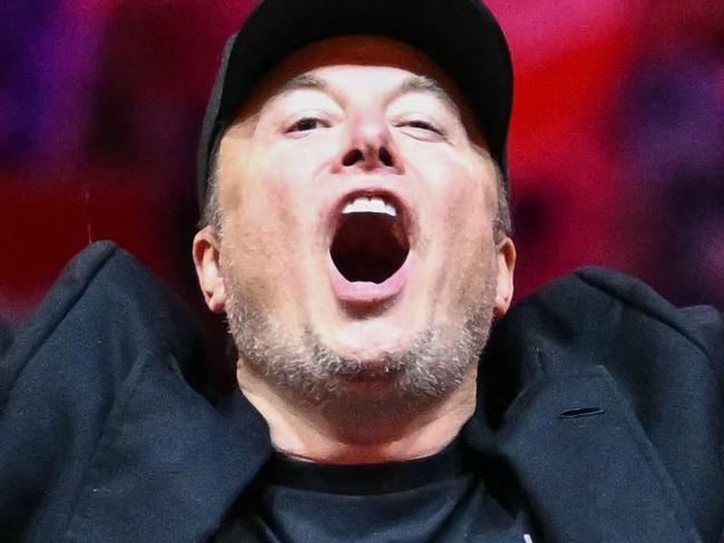 TOPSHOT - Tesla and SpaceX CEO Elon Musk gestures as he steps on stage during a rally for former US President and Republican presidential candidate Donald Trump at Madison Square Garden in New York, October 27, 2024. (Photo by ANGELA WEISS / AFP)