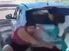Woman holding baby tries to stop brawl