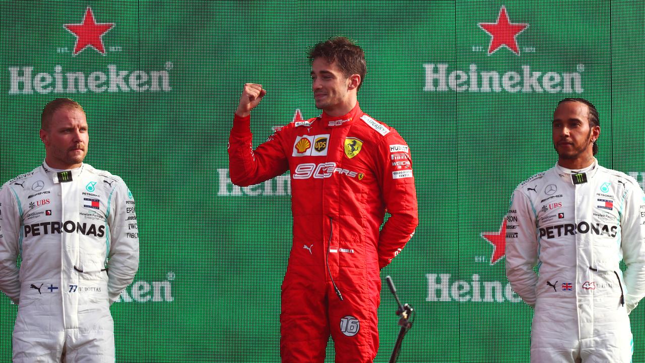 Charles Leclerc (C) celebrates on the podium with Valtteri Bottas (R) and Lewis Hamilton (R) in Monza.