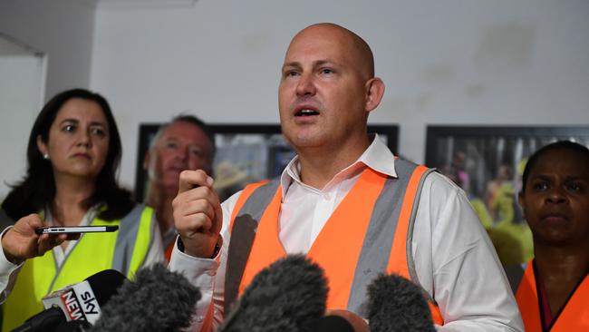 Premier Annastacia Palaszczuk watches Treasurer Curtis Pitt speaking at a press conference during a visit to a construction site in Cairns on Monday. (AAP Image/Dan Peled)