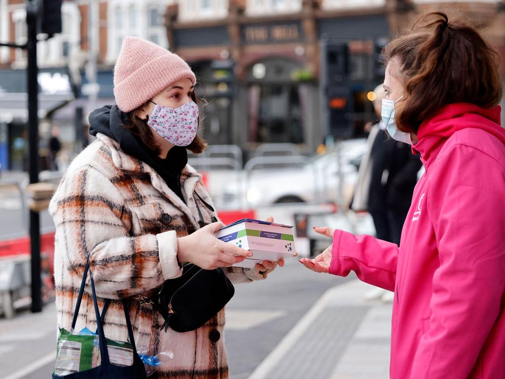 Volunteers hand out rapid antigen tests in London. Picture: Tolga Akmen/AFP