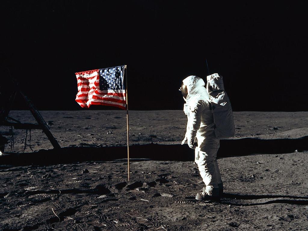 Astronaut Edwin E. Aldrin Jr., lunar module pilot of the first lunar landing mission, poses for a photograph beside the deployed United States flag. Picture: NASA