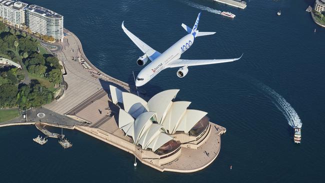 SYDNEY, AUSTRALIA - MAY 02: An Airbus A350-1000 flight test aircraft flies over Sydney Harbour to mark a major fleet announcement by Australian airline Qantas on May 02, 2022 in Sydney, Australia. Twelve Airbus A350-1000's will be ordered to operate non-stop "Project Sunrise" flights from Australia's east coast to New York, London and other key destinations. The aircraft will feature market-leading passenger comfort in each travel class with services to start by the end of 2025. (Photo by James D. Morgan/Getty Images for Airbus/Qantas) *** BESTPIX ***