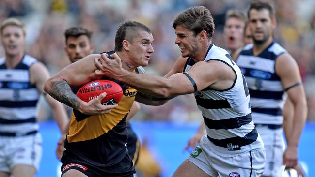 Tom Hawkins of the Cats tackles Dustin Martin of the Tigers, during the round 5 AFL match between the Richmond Tigers and Geelong Cats, at the MCG in Melbourne, Saturday May 2, 2015. (AAP Image/Joe Castro) NO ARCHIVING, EDITORIAL USE ONLY