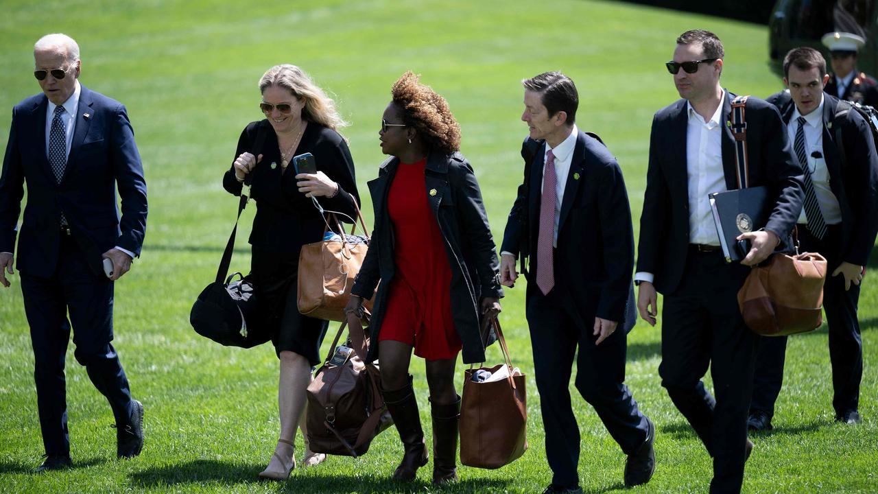 Staff walk alongside Joe Biden from Marine One the White House. Picture: Brendan Smialowski/AFP