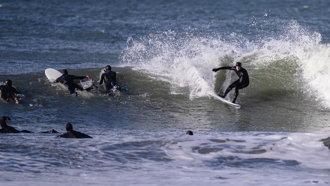 Surfers at Seven Mile Beach. Picture: Linda Higginson