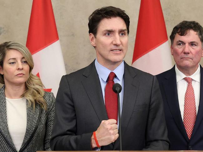 Canada's Prime Minister Justin Trudeau hits back at the US, flanked by Minister of Foreign Affairs Melanie Joly and Minister of Finance and Intergovernmental Affairs Dominic LeBlanc, during a news conference February 1 in Ottawa, Canada. Picture: Dave Chan / AFP