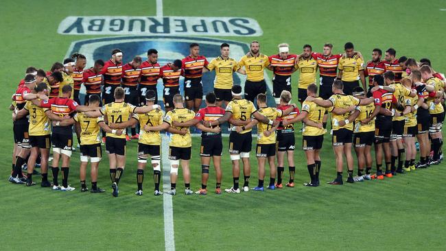 The Chiefs and Hurricanes come together for a moments silence prior to the start of their Super Rugby match. Picture: Getty