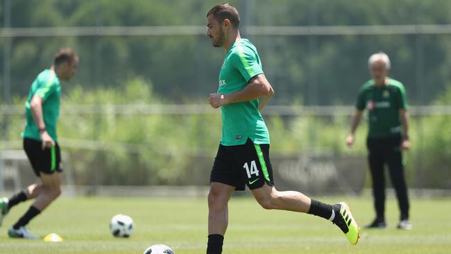 James Troisi is watched closely by Bert van Marwijk.