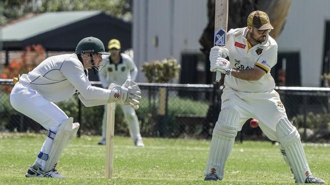 MPCA: Seaford wicketkeeper Craig Roscoe with his hands illegally in front of the stumps and Heatherhill batsman Zach Horsley. Picture: Valeriu Campan