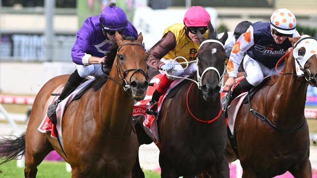 Foxy Cleopatra (pink cap) runs second in the Cranbourne Cup.