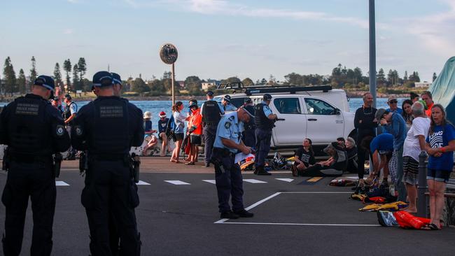 Police officers speak to people after a series of arrests. Picture: Roni Bintang/Getty Images