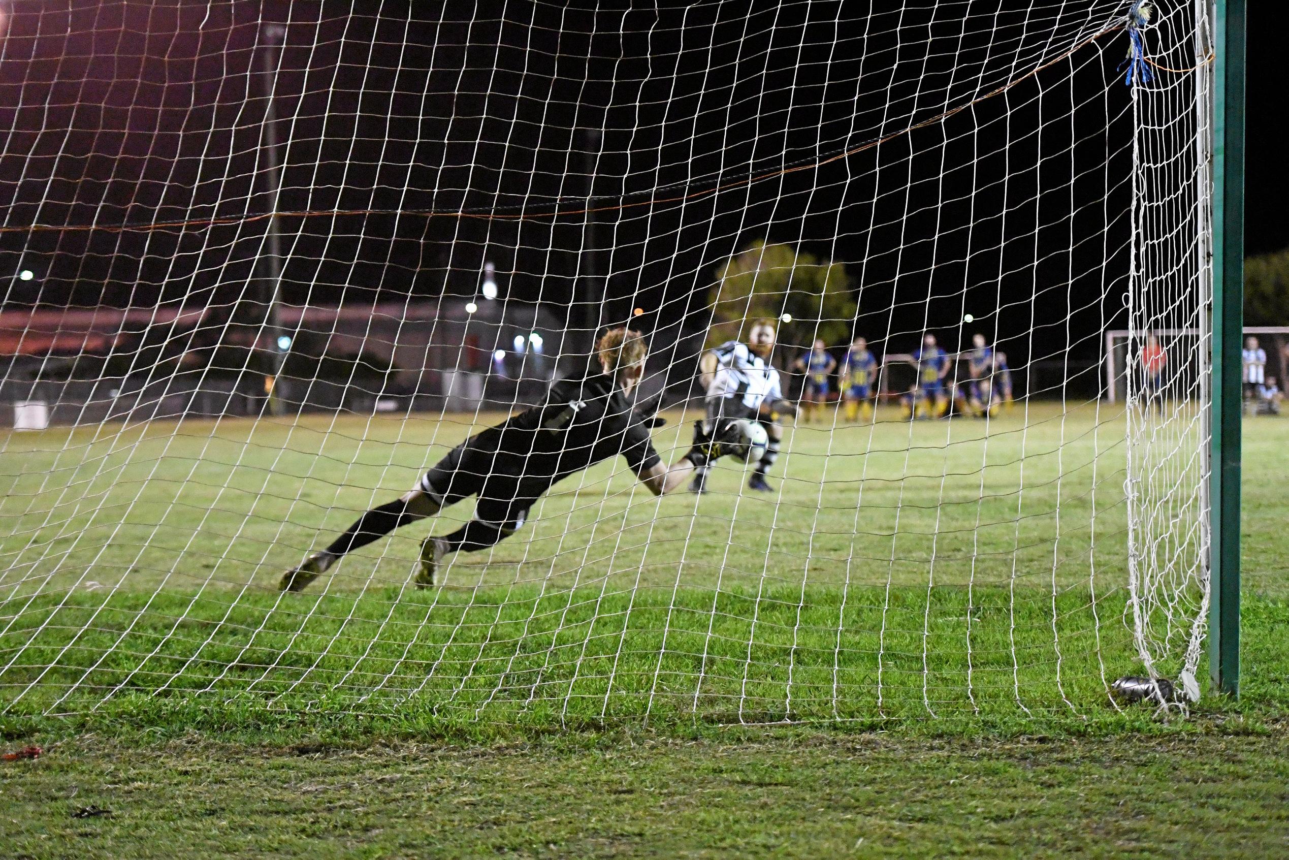 The Waves' Sam Collinson saves a shot from Bingera's Shaun Sergiacomi. Picture: Shane Jones