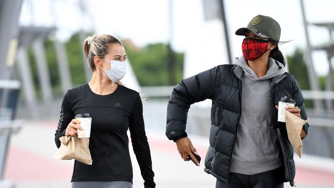 Maria Meza (left) and Alicia Faavae grab a coffee on their morning walk in Southbank, during the first day of COVID-19 lockdown in Brisbane. Picture: NCA NewsWire / Dan Peled