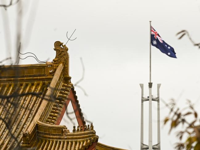 The flagpole of the Australian parliament behind the roof of the Chinese Embassy in Canberra. Picture: AAP Image/Lukas Coch